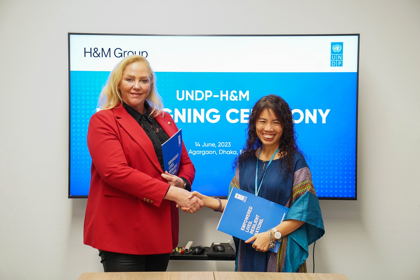 UNDP Bangladesh and H&M Group, exchanging signed documents during the partnership signing ceremony