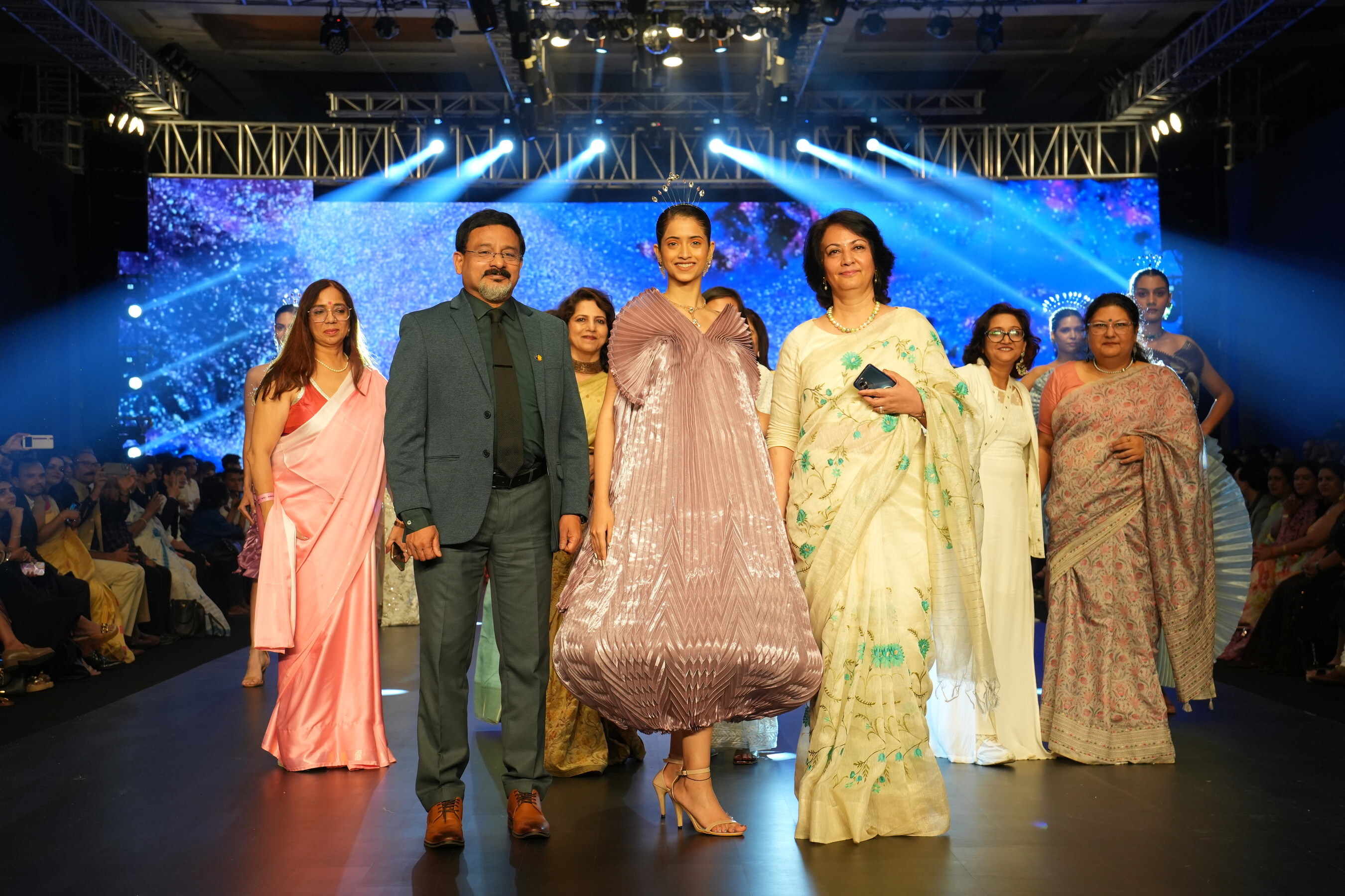 L to R: Prof. (Dr.) AW. Santhosh Kumar, Vice-Chancellor, Amity University Mumbai, Esha Velankar, showstopper and student Amity School of Fashion Technology (ASFT) and Prof. (Dr.) Bhawana Chanana, Head of Institution, Amity School of Fashion Technology, Amity University Mumbai, walk the ramp at the Bombay Times Fashion Week 2024, during the finale of the display of the students’ spectacular collect
