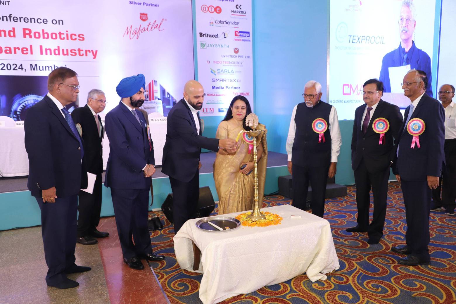 Chief Guest Ms. Roop Rashi, Textile Commissioner, Ministry of Textiles, Govt. of India lighting the lamp.  Standing (L to R): Mr. R. R. Patil, Vice President, TAI, Mumbai Unit, Mr. Rajiv Ranjan, President, TAI, Mumbai Unit, Mr. Navdeep S. Sodhi, Partner, Gherzi Textil Organisation, Zurich, Mr. Priyavrata Mafatlal, Managing Director, Mafatlal Industries Ltd., Ms. Roop Rashi, Textile Commissioner, M