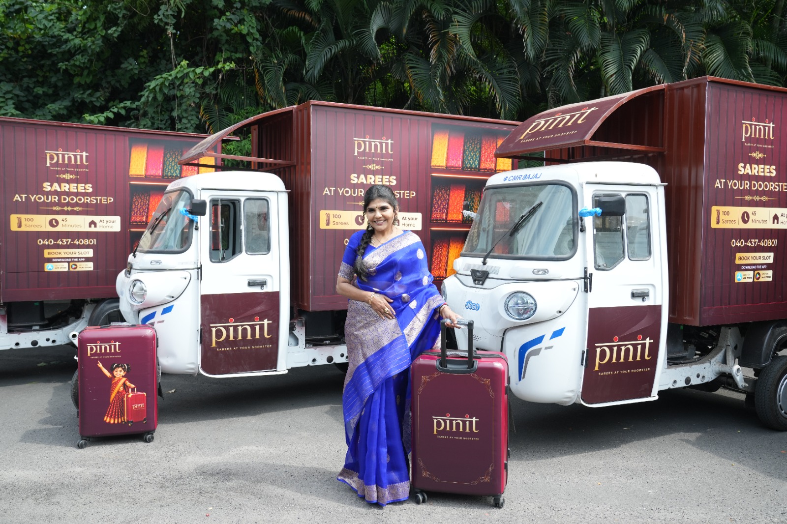 Sangeetha Rajesh, Founder, Pinit with the brand all electric fleet showcasing a suitcase of curated sarees that will be taken to customers doorstep